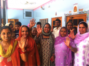Female farmers from India waving goodbye to the research team. Credit: Arame Tall (CCAFS)