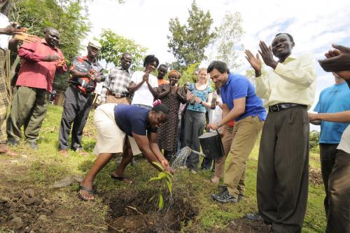 Rosemary Ogolla of CARE Climate Change plants a ceremonial tree in the village of Othidhe, Kenya. Photo by Neil Palmer