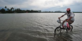 A man and his bicycle seem to float on water as the road. Source: https://www.flickr.com/photos/ricephotos/7771383140/